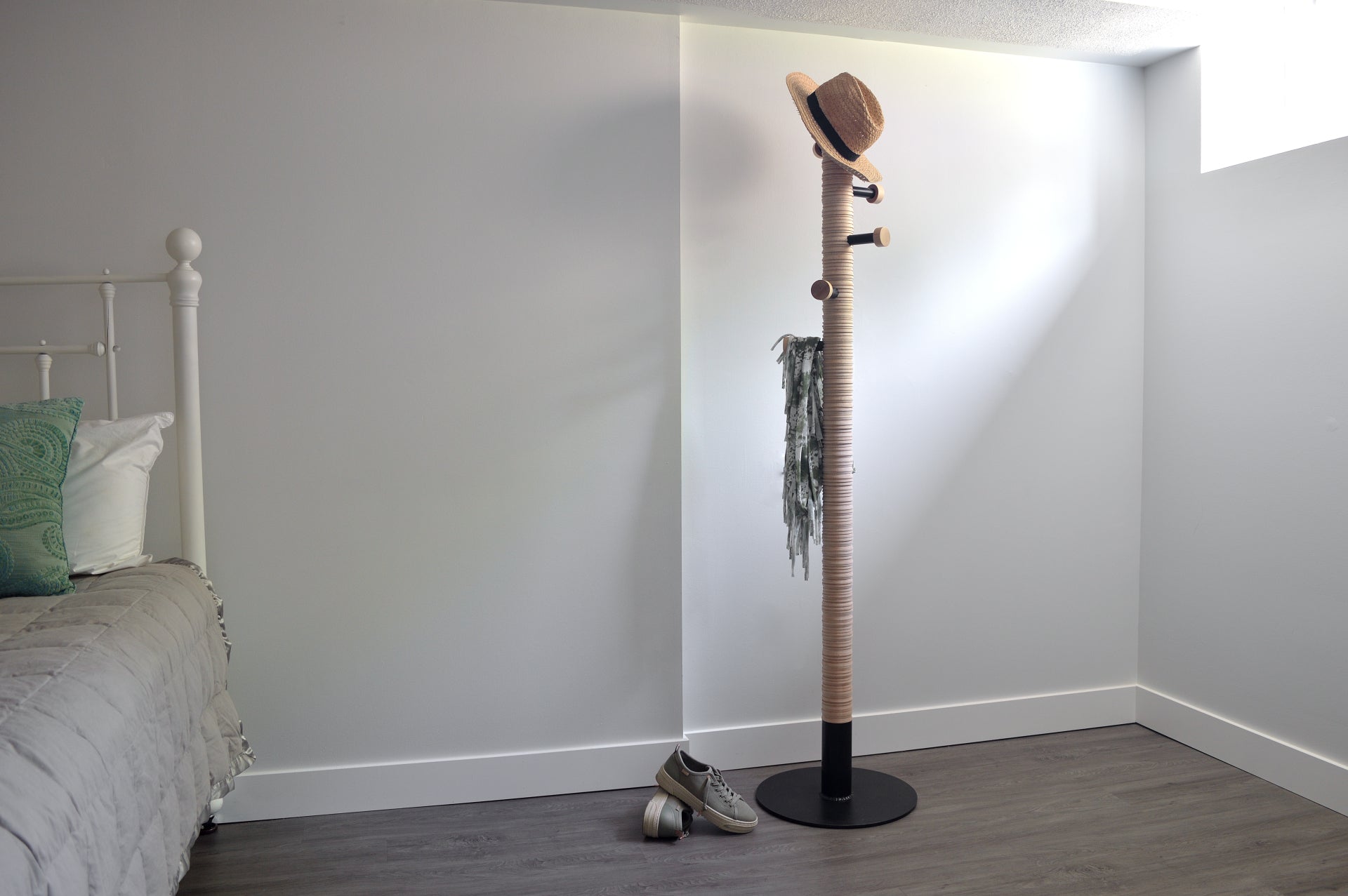 Coat rack with a hat and scarf in a bedroom setting